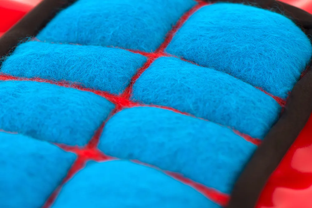Détail : abdominaux rembourrés en lainage bleu